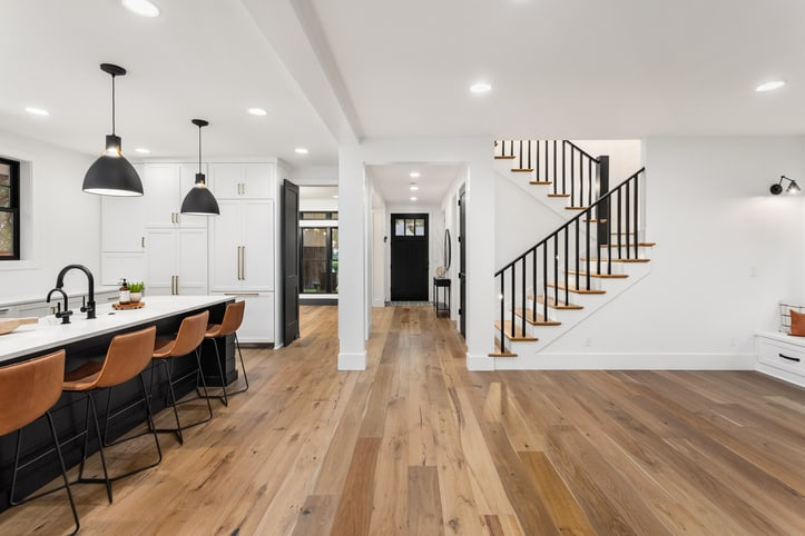 Modern open kitchen and living area with hardwood flooring